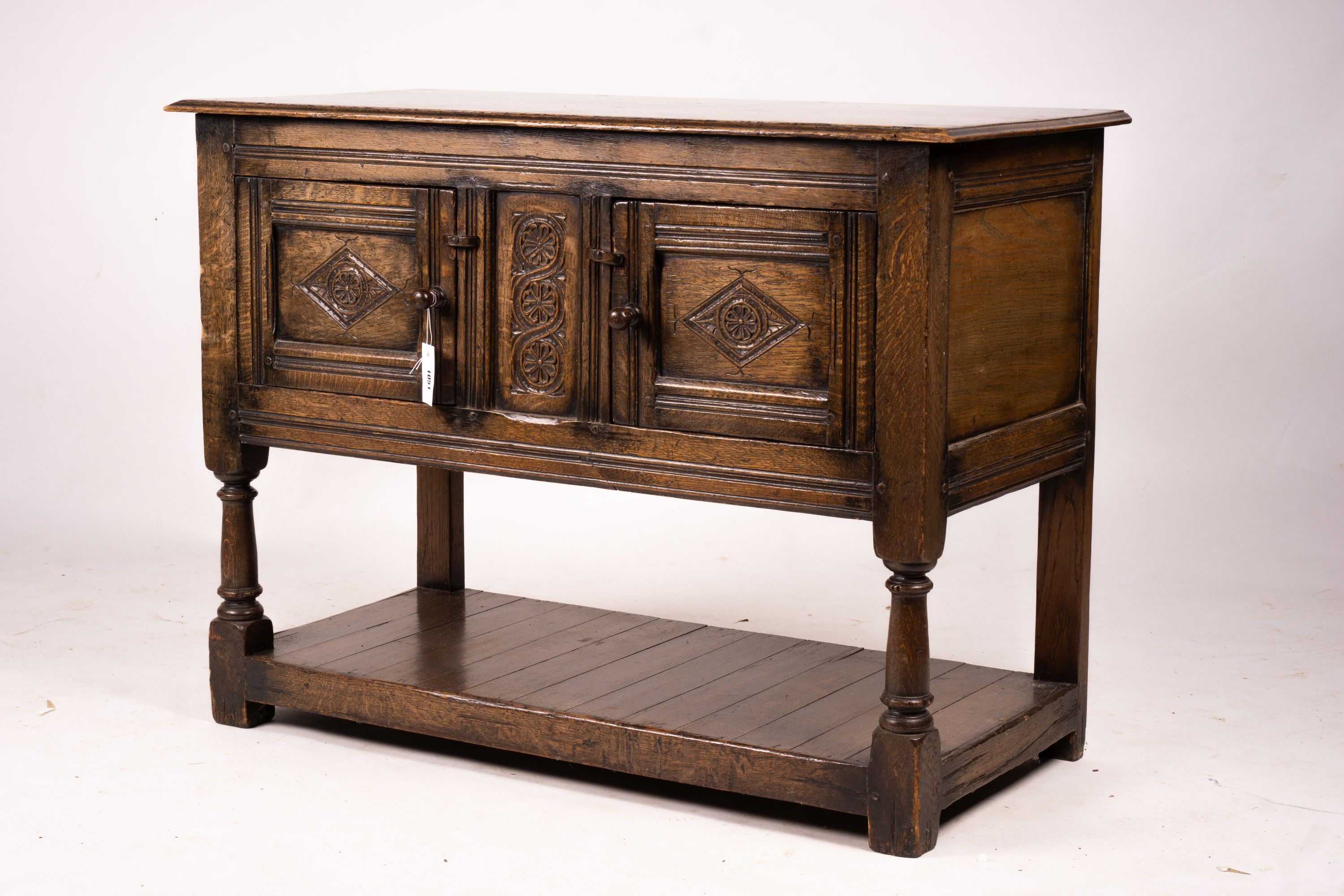 An 18th century style oak two door low cupboard, width 106cm, depth 50cm, height 78cm